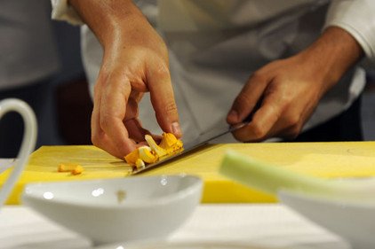 Koch bereitet Pilzbouillon zu